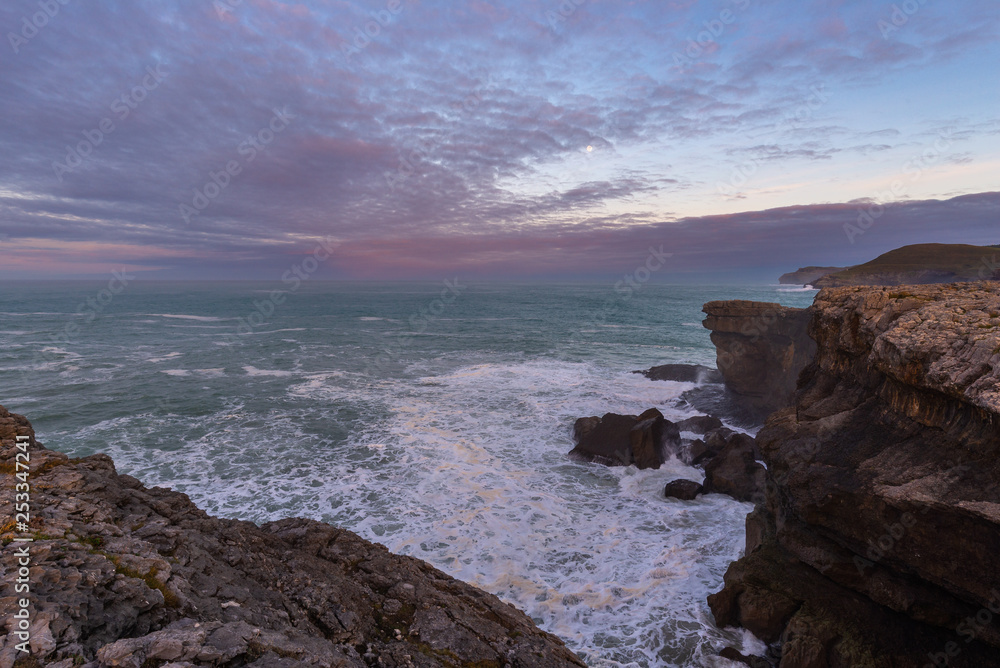 Rocky coast of Ajo Cape at sunrise, Cantabria, Spain