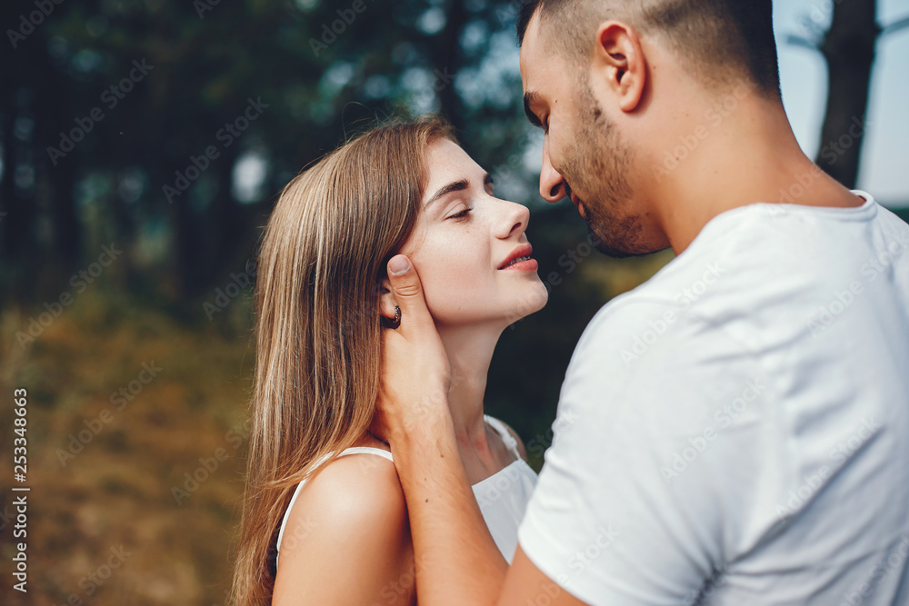 Beautiful couple spend time in a summer park Beautiful couple spend time in a summer park
