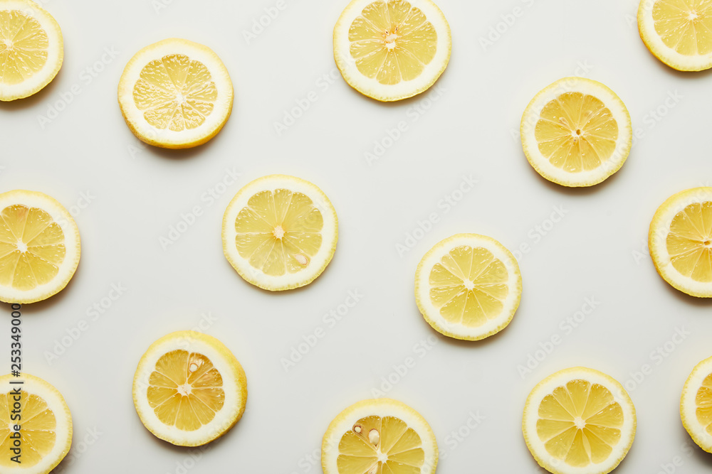 Top view of juicy lemon slices on grey background