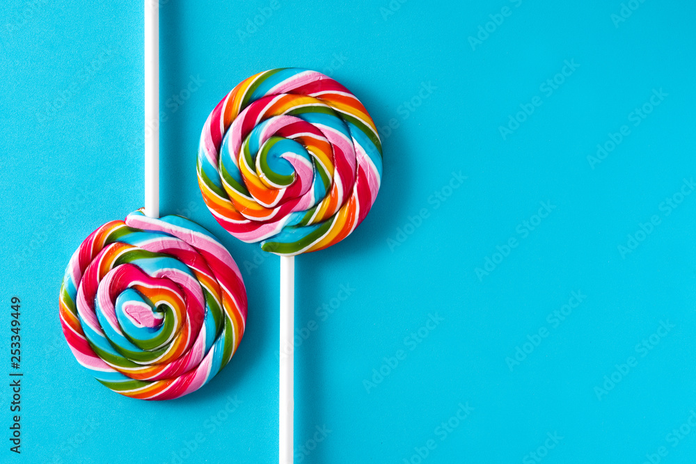 Colorful lollipops on blue background. Copyspace Colorful lollipops on blue background. Copyspace