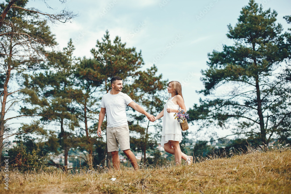 Beautiful couple spend time in a summer park Beautiful couple spend time in a summer park