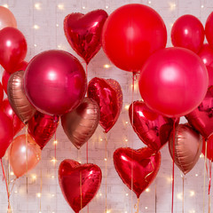 Valentine's day background - group of red air balloons over brick wall