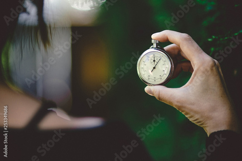 woman holding an old chronometer