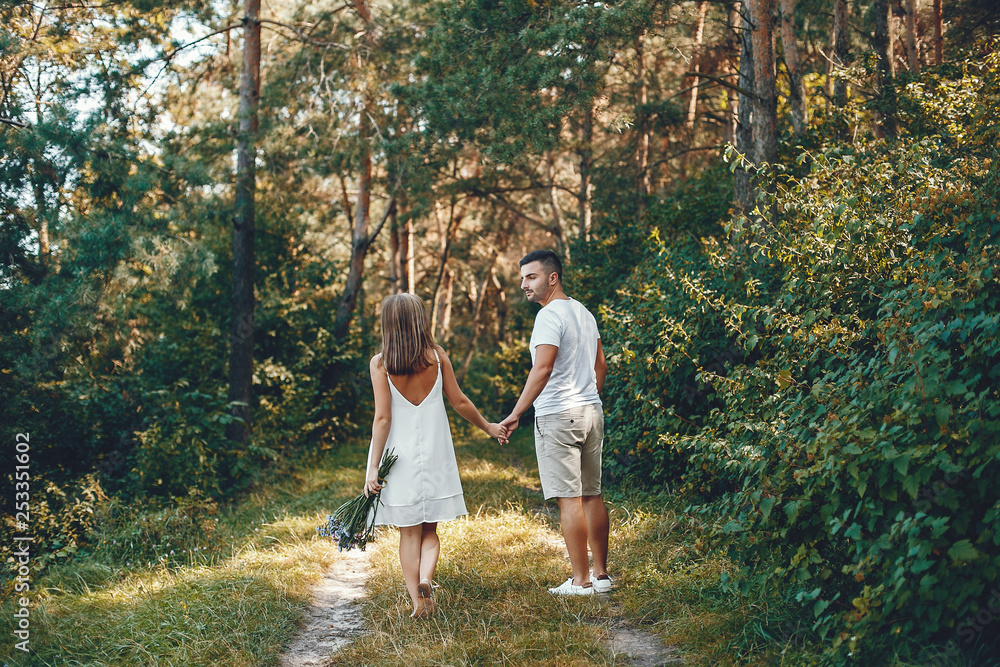 Fototapeta premium Beautiful couple spend time in a summer park