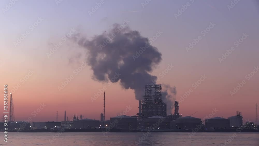 a huge steamy cloud rising from a petroleum refinery at the port of Antwerp at dawn a huge steamy cloud rising from a petroleum refinery at the port of Antwerp at dawn