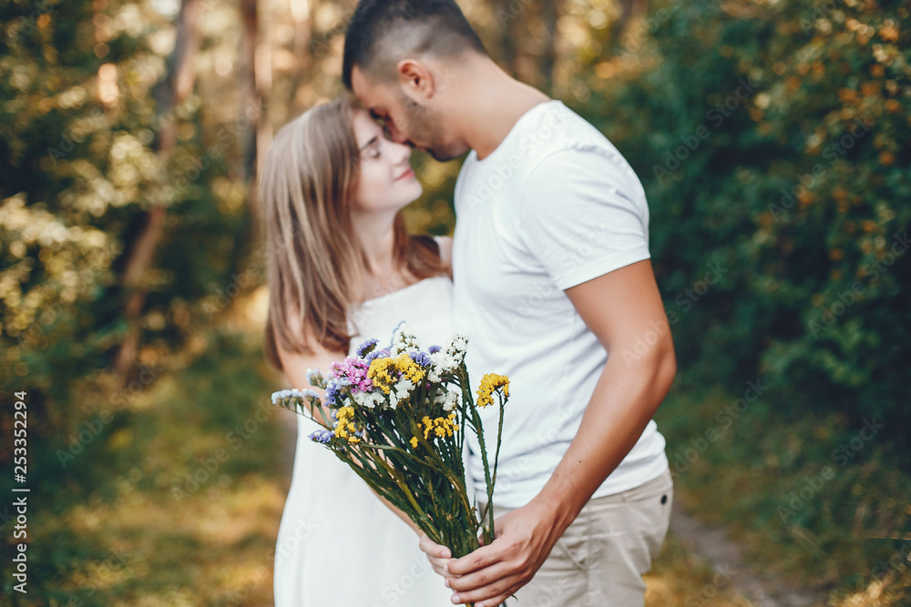 Beautiful couple spend time in a summer park Beautiful couple spend time in a summer park