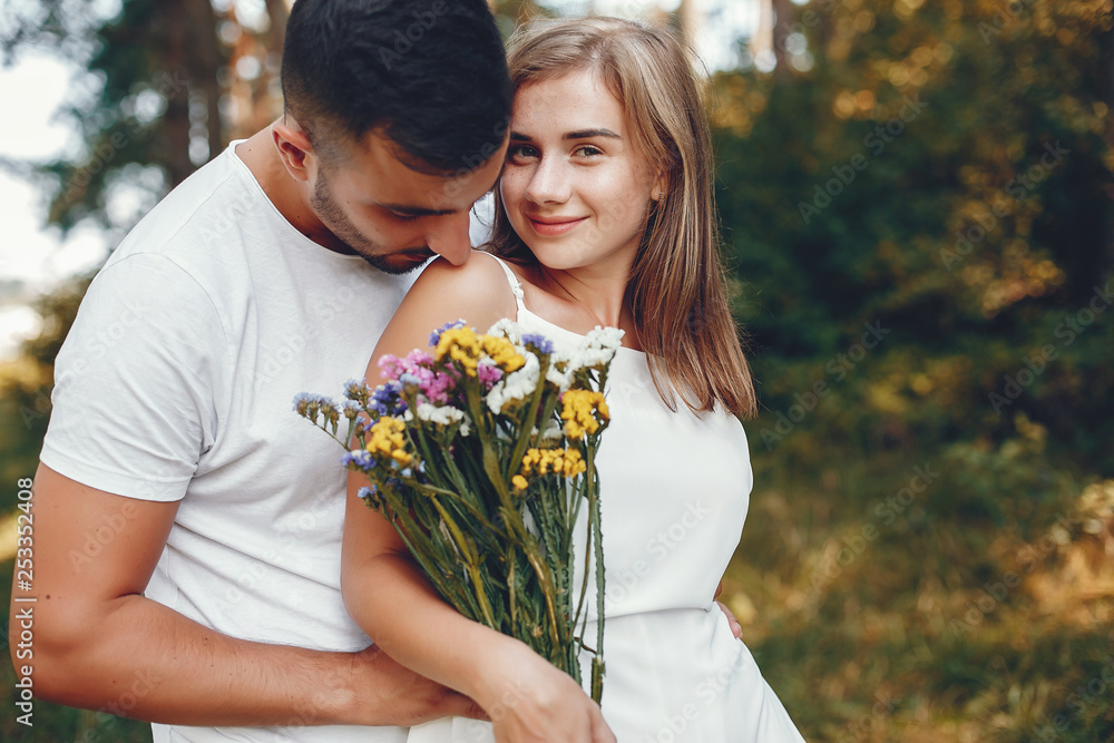 Beautiful couple spend time in a summer park Beautiful couple spend time in a summer park