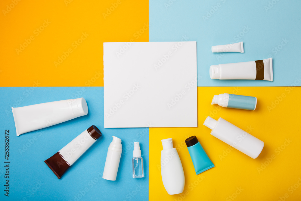 Mock up summer skin care cosmetics on yellow and blue background. White bottles of woman cosmetics on yellow. Summer holidays or vacation. Preparation for summer care. Sunscreen protection products Mock up summer skin care cosmetics on yellow and blue background. White bottles of woman cosmetics on yellow. Summer holidays or vacation. Preparation for summer care. Sunscreen protection products