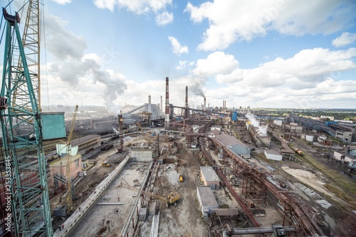 landscape, panorama, view of factory slums with metal hulls and machines for the production of the coking industry, smoking pipes and reconstruction of a plant in Ukraine
