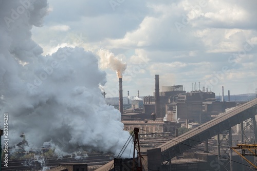 landscape  panorama  view of factory slums with metal hulls and machines for the production of the coking industry  smoking pipes and reconstruction of a plant in Ukraine
