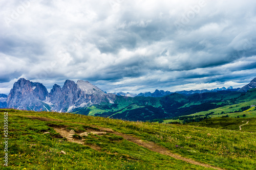 Alpe di Siusi, Seiser Alm with Sassolungo Langkofel Dolomite, a large green field with a mountain in the background © SkandaRamana