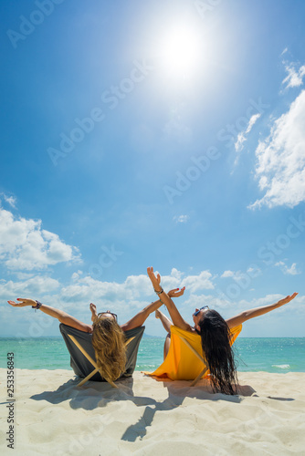 Two Women enjoying their holidays on the tropical beach