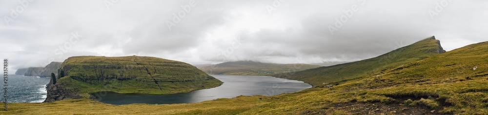 panorama of the Bosdalafossur waterfall hike around the Sorvagsvatn lake at the Vagar Island of the Faroe islands archipelago in the summer 