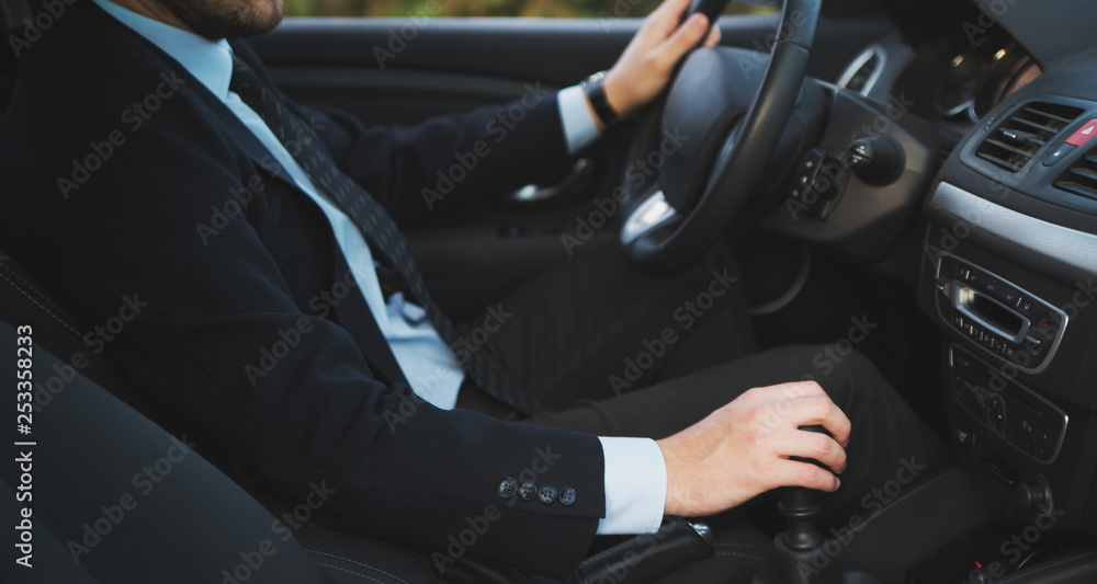 Business man driver hand shifting the gear stick Business man driver hand shifting the gear stick