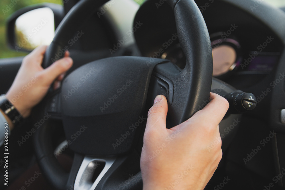 Man driving a vehicle. Hand with rudder