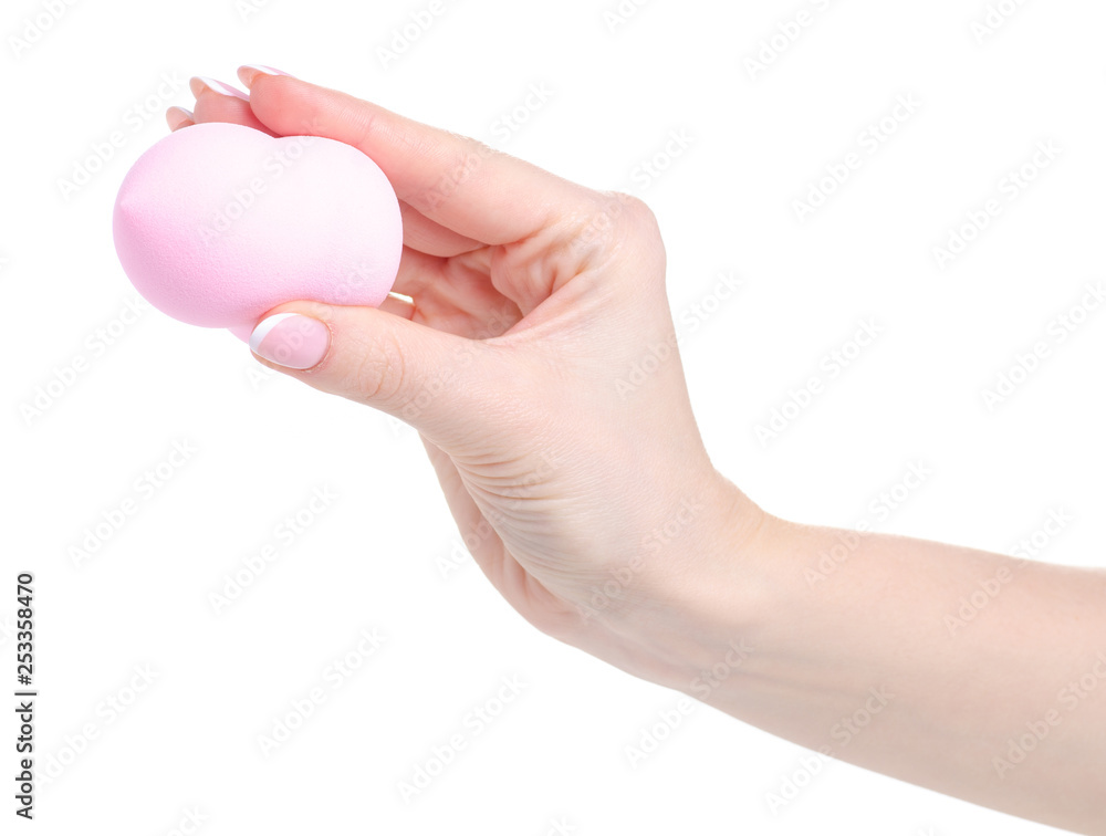Make up pink sponge puff in hand on white background isolation Make up pink sponge puff in hand on white background isolation