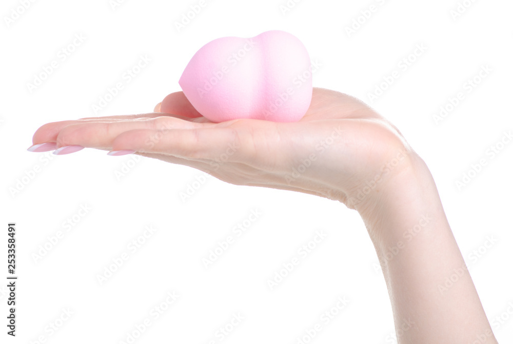 Make up pink sponge puff in hand on white background isolation Make up pink sponge puff in hand on white background isolation