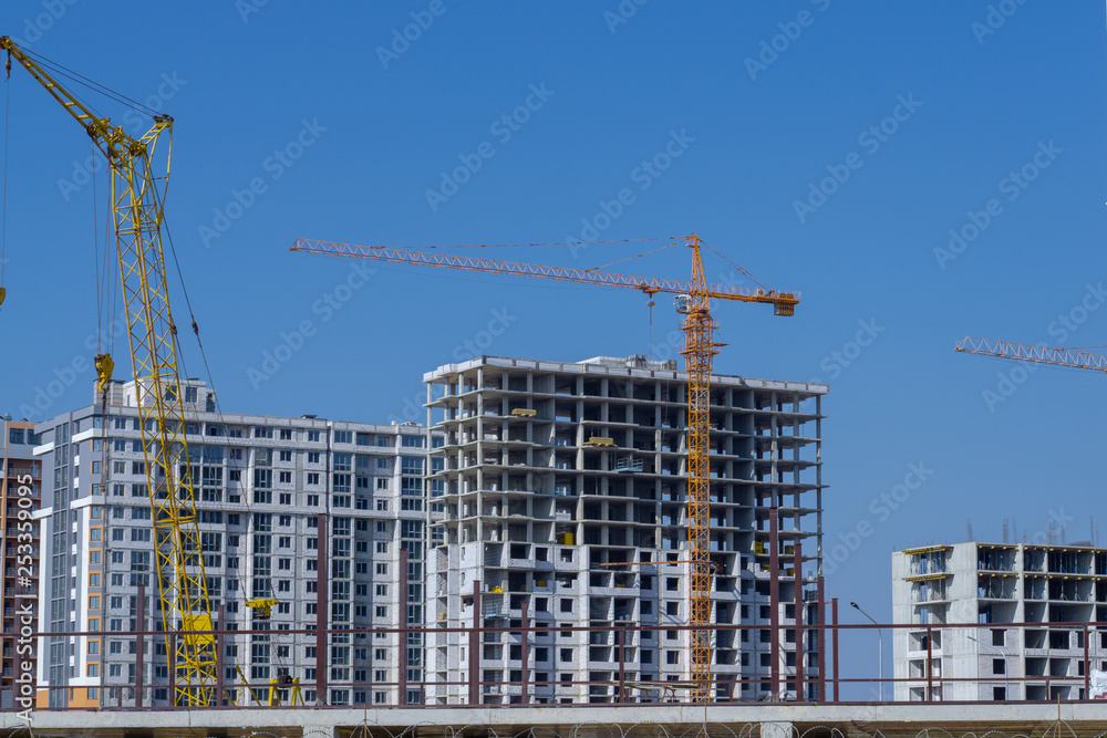Construction crane and high-rise building under construction