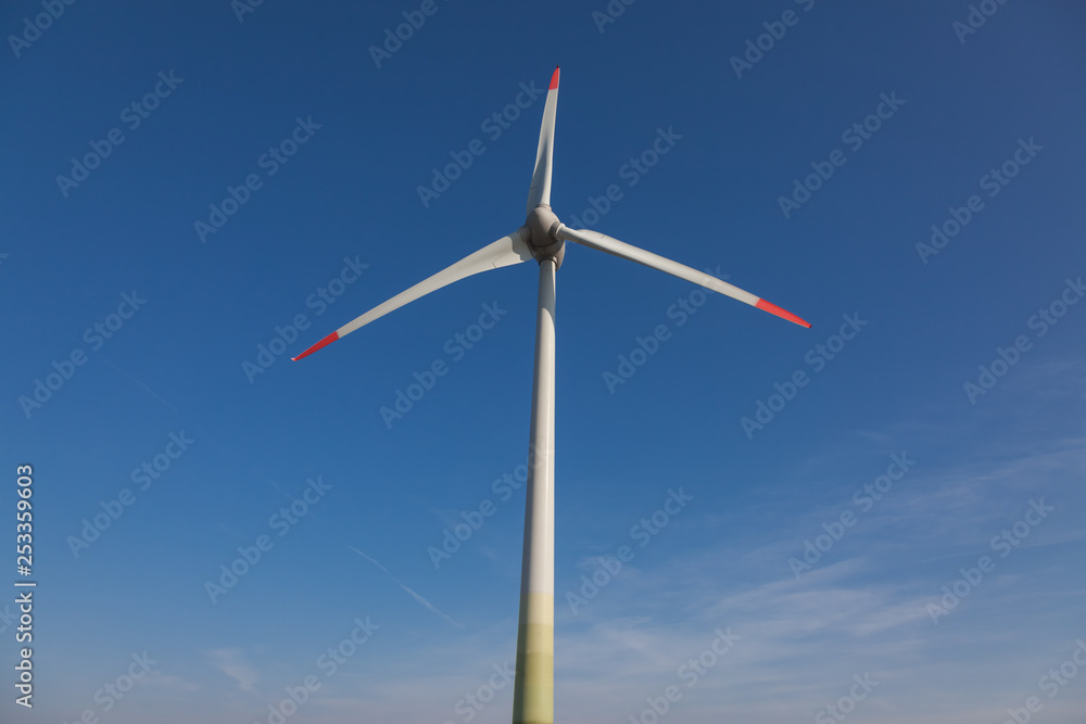 wind turbine with sun flare blue sky background view from below wind turbine with sun flare blue sky background view from below