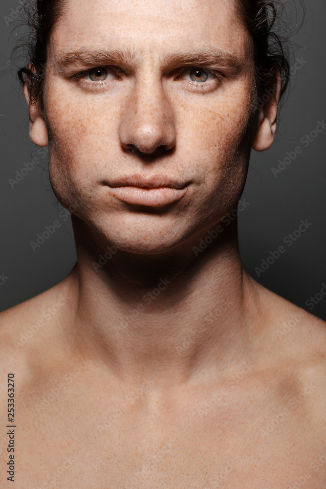 Portrait of a muscular long-haired man with drawn hair and freckles, topless Portrait of a muscular long-haired man with drawn hair and freckles, topless