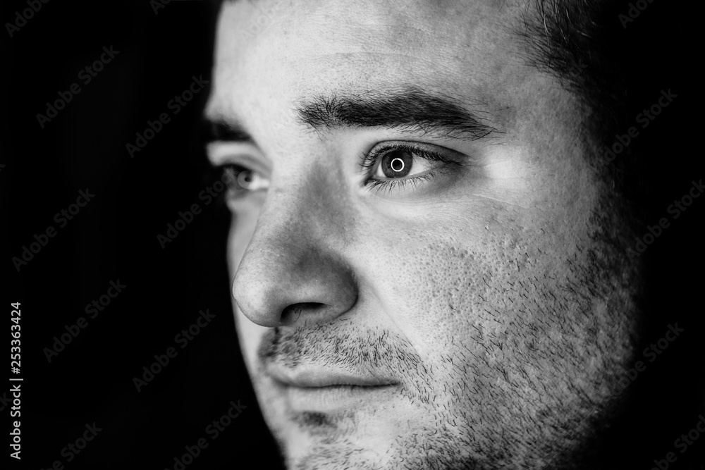close up half side portrait of a young man. studio shot. led ring reflection in the eyes close up half side portrait of a young man. studio shot. led ring reflection in the eyes