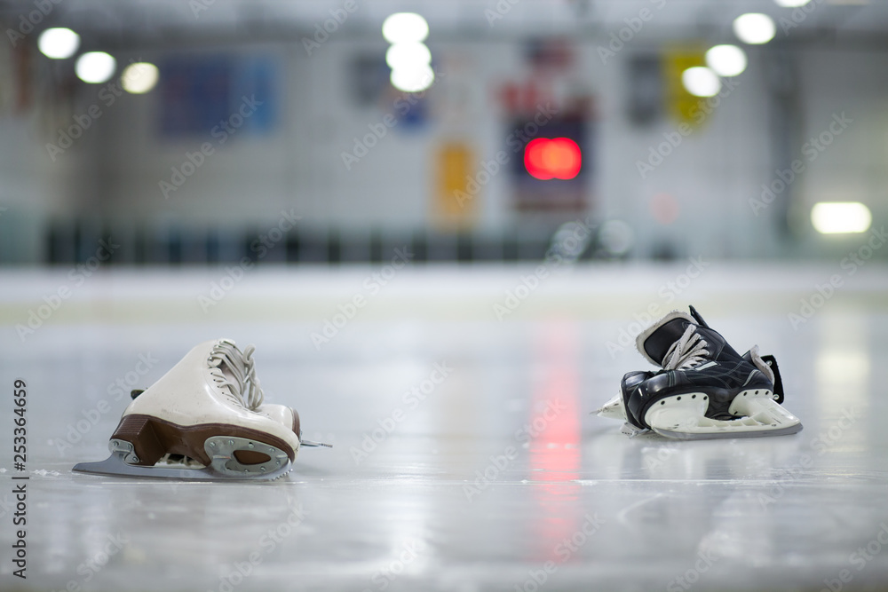 Figure Skates and Hockey Skates on Ice Rink - obrazy, fototapety, plakaty 