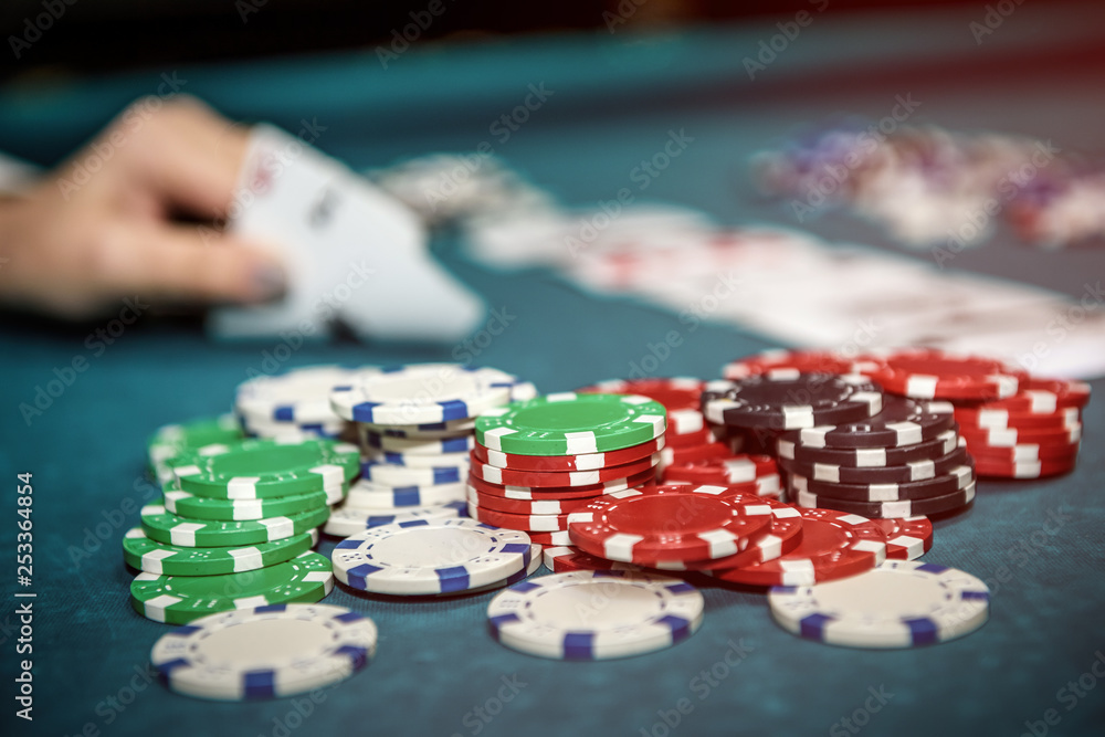 Female hand with playing cards and poker chips close up Female hand with playing cards and poker chips close up