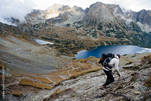Male hiker with backpack standing on mountain