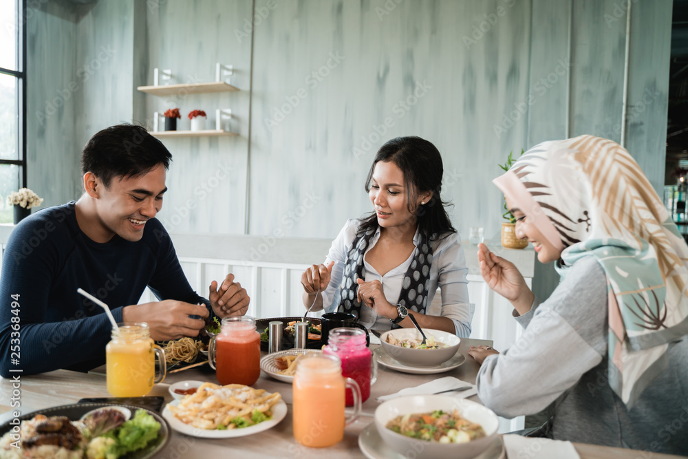 group of friends enjoy eating together in a restaurant