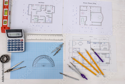 Millimeter paper with drawing tools and house plan