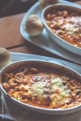 Combinazione, an Italian dish combined with Lasagne, Spaghetti and tortellini dumplings baked in a dish. Shallow depth of field, noisy instagram filter.