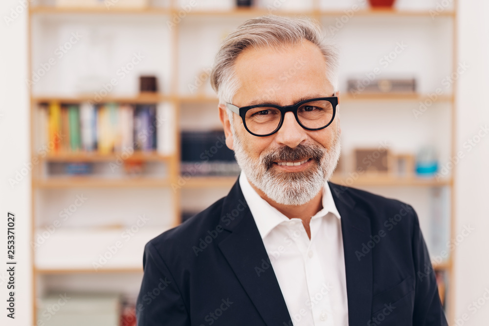 Senior bearded professional man smiling at camera Senior bearded professional man smiling at camera