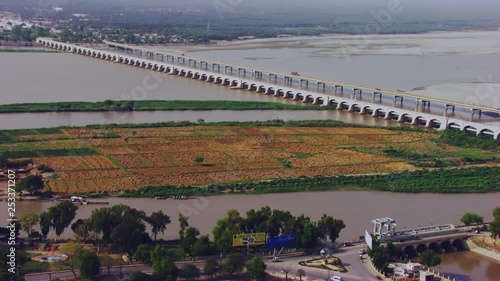 Aerial view of twins bridges over the river and city with electric towers, big canal starting from the river going between the city, Rural and urban areas gathered Khyberpakhtunkhwa, Pakistan photo