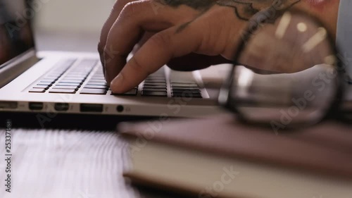 Wallpaper Mural Close-up of hands of a young man typing on a laptop keyboard, finishing work and closing a netbook. Torontodigital.ca