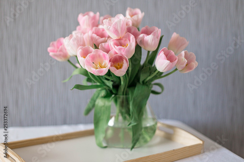 Wallpaper Mural A bouquet of spring beautiful flowers in a glass vase. Fresh Pink tulips on white background. Torontodigital.ca