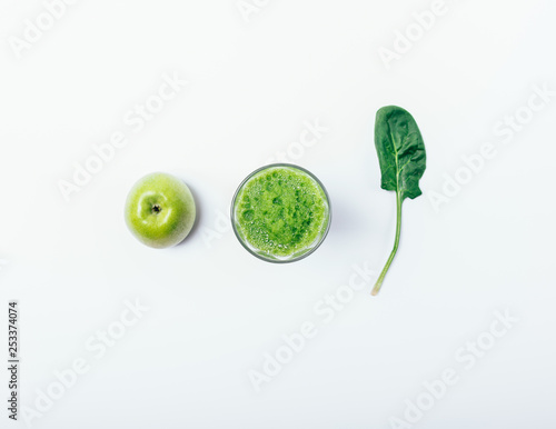Creative flat lay composition of glass of green smoothie