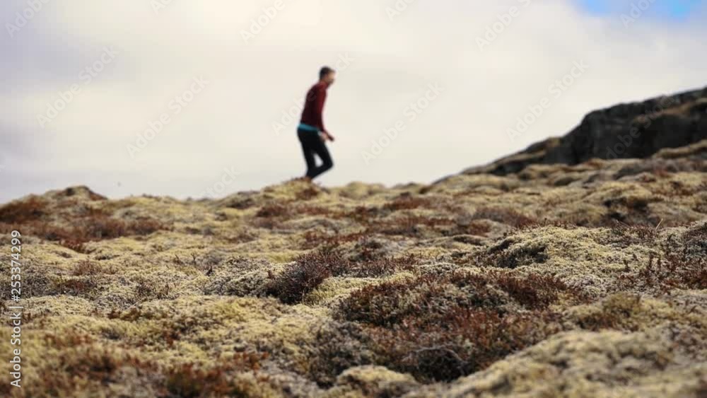 Man out of focus, walking through Icelandic landscape. Man out of focus, walking through Icelandic landscape.
