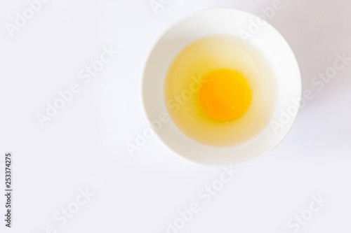 whole egg broken egg with egg shells in a bowl with white background