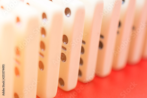 Dominoes on red table photo