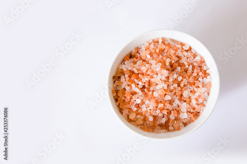 Himalayan mountain pink rock salt on a white background in a round bowl
