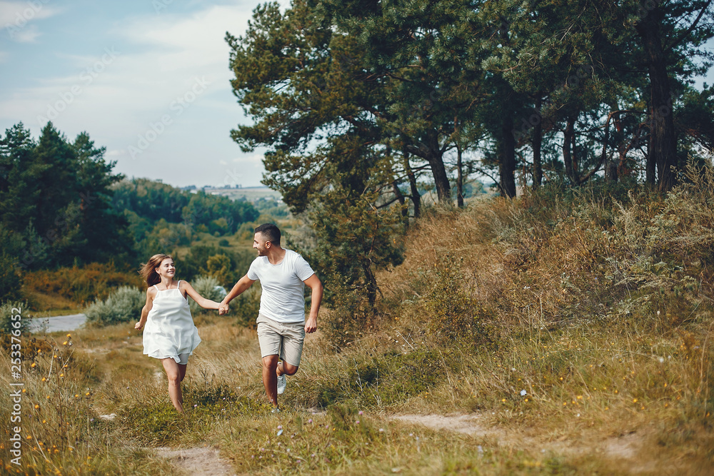 Beautiful couple spend time in a summer park Beautiful couple spend time in a summer park