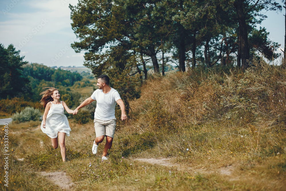 Beautiful couple spend time in a summer park