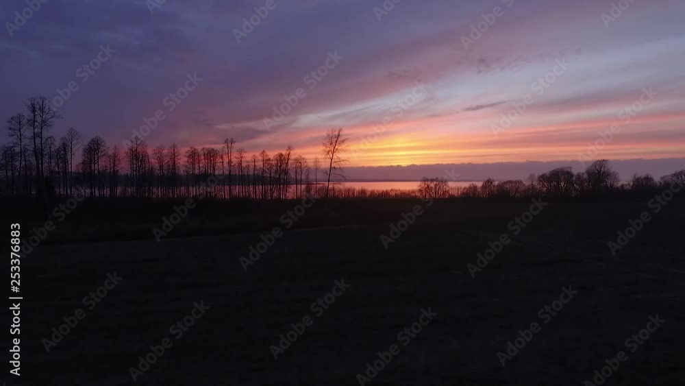 Lake Burtnieks in late autumn red sky sunset aerial wide view wit tree silhouette Lake Burtnieks in late autumn red sky sunset aerial wide view wit tree silhouette