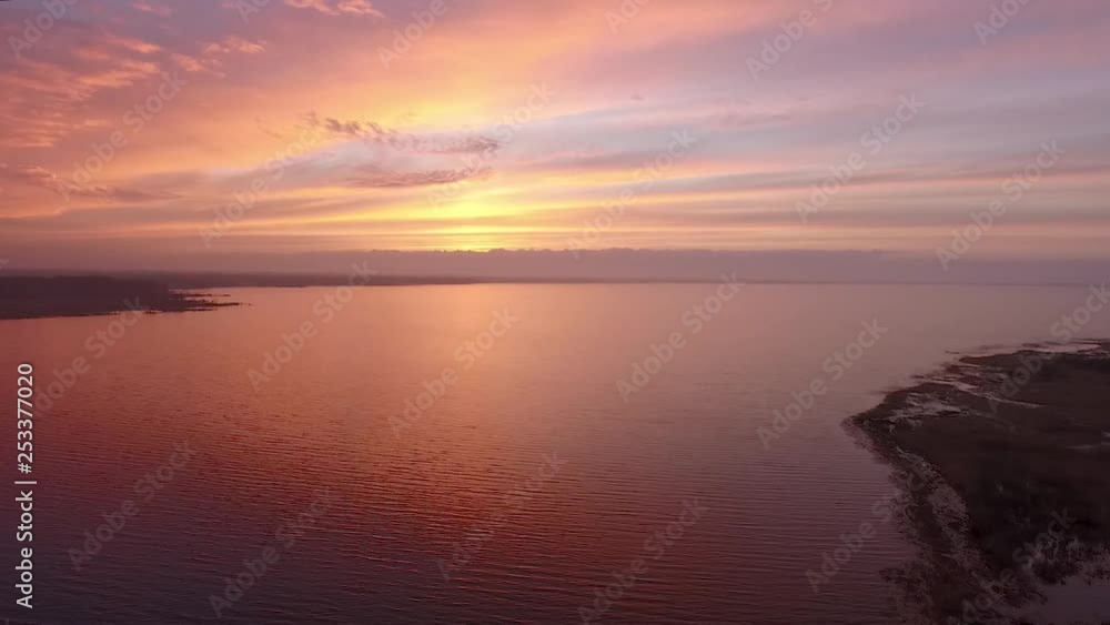 Lake Burtnieks in late autumn red sky sunset aerial wide view wit tree silhouette Lake Burtnieks in late autumn red sky sunset aerial wide view wit tree silhouette