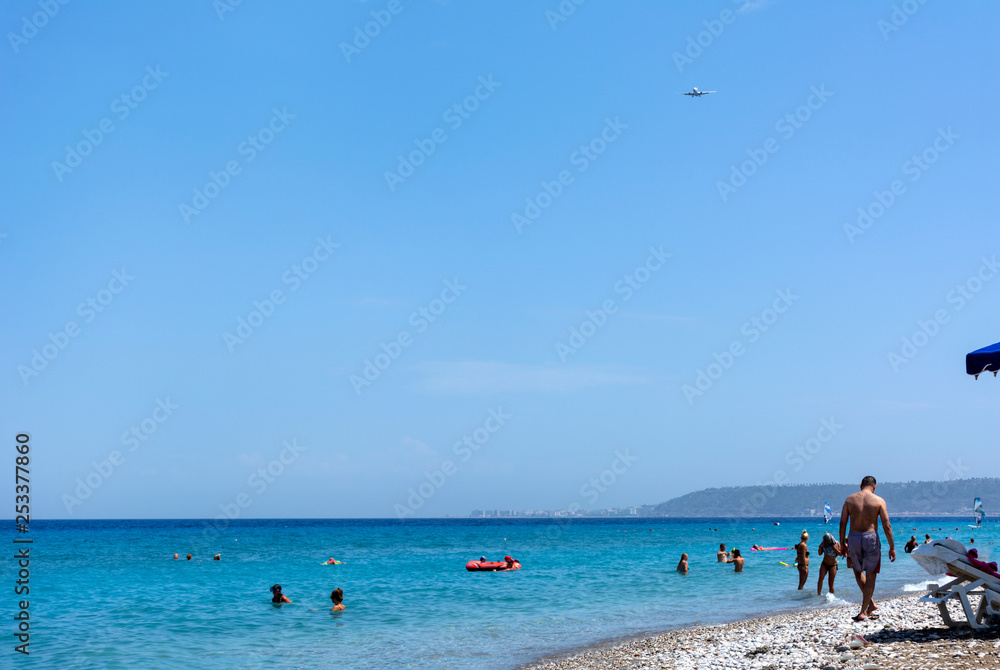beach, Aegean sea, people on the beach, people swimming in the sea, plane in the Sky, Rhodes coast