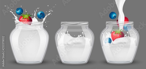 Set of glass jars with yogurt and berries.