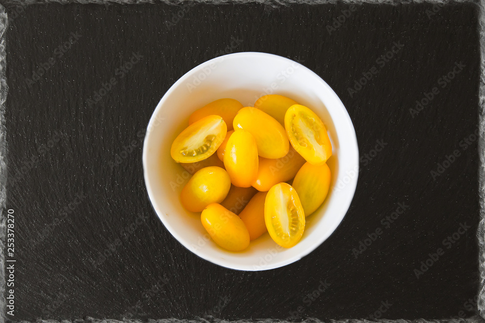 Exotic tomatoes rosa yellow tomatoes on a black background Exotic tomatoes rosa yellow tomatoes on a black background