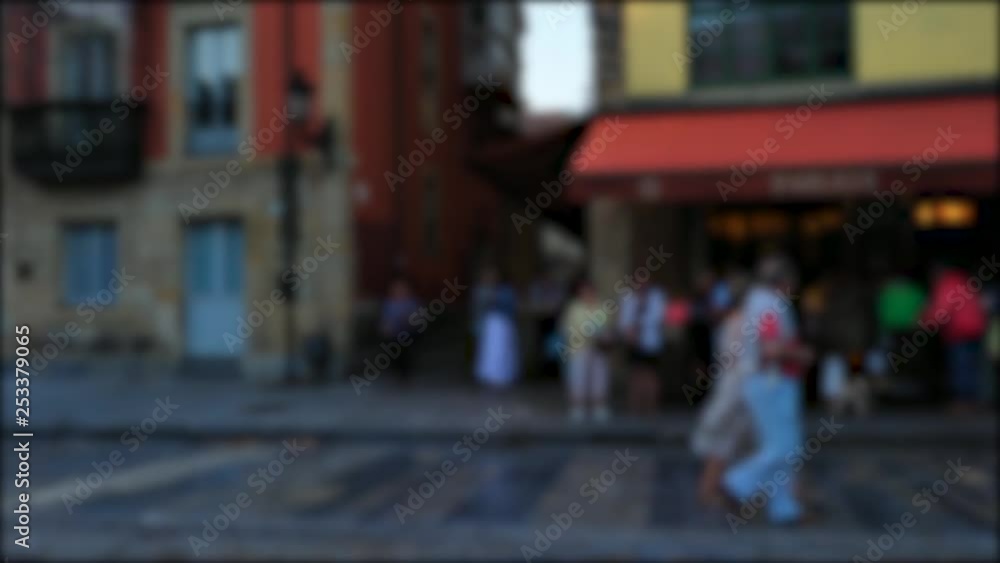 People calmly walking at a public square in Gijon, Spain. Slow motion shot. People calmly walking at a public square in Gijon, Spain. Slow motion shot.