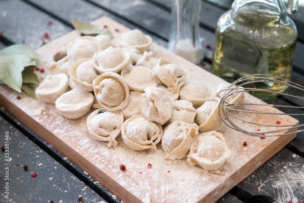 Fototapeta premium dumplings, raw dumplings, flour, wooden Board,