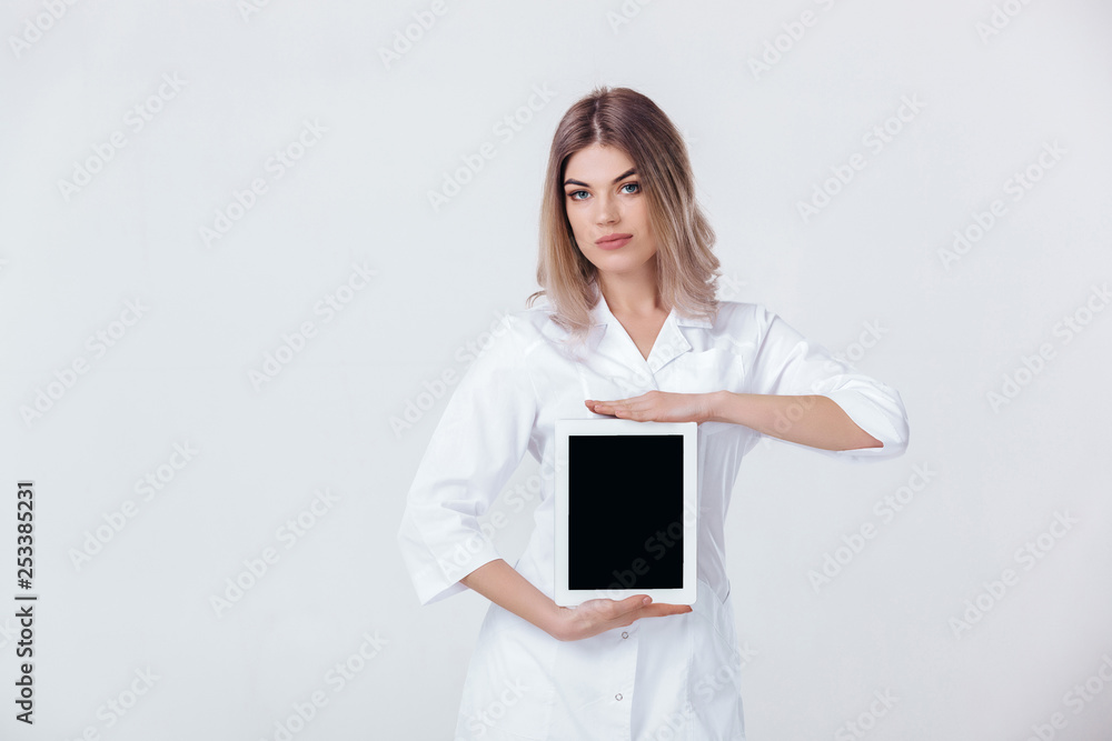 Portrait of beautiful blonde doctor in white coat showing screen of digital tablet in her hand. Healthcare and technology concept. Portrait of beautiful blonde doctor in white coat showing screen of digital tablet in her hand. Healthcare and technology concept.